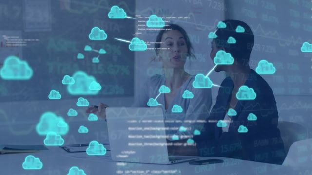 Businesswomen are collaborating in a corporate office with digital cloud icons overlaying the scene, representing cloud computing and digital data processing. This is perfect for illustrating concepts related to teamwork, innovation, digital transformation, and modern business technology solutions.