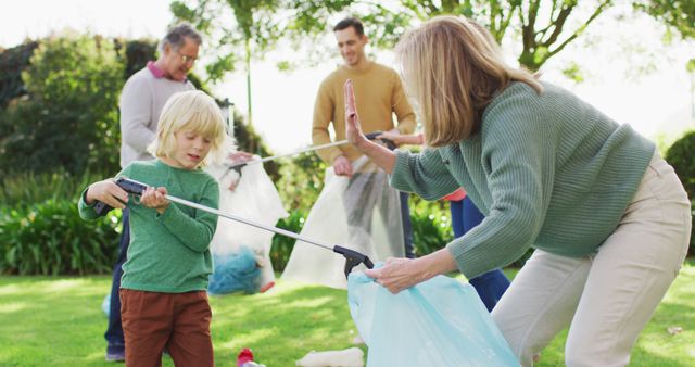 Image of smiling caucasian grandson high fiving grandmother while collecting plastic for recycling. Family, domestic life, togetherness, recycling and waste concept digitally generated image.