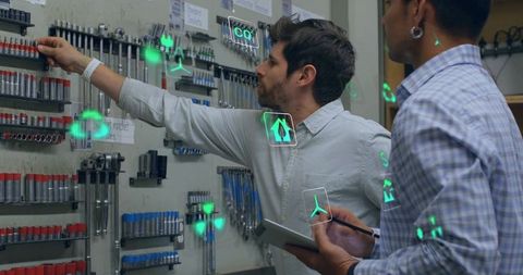 Technicians using tablet and ar inspecting workshop tools on organized pegboard
