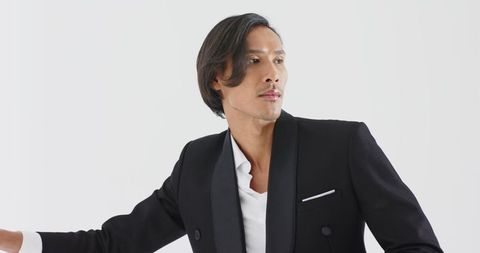Elegant asian man posing in black double-breasted suit jacket