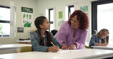 Teacher Guiding Student in Eco-Friendly Classroom Setting