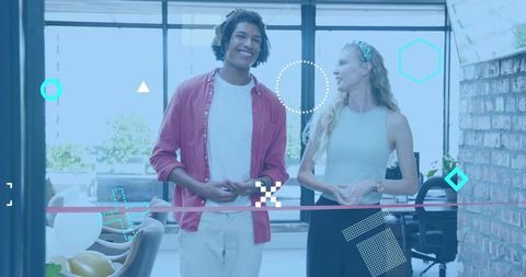 Young professionals chatting in bright coworking lounge with balloons and modern decor