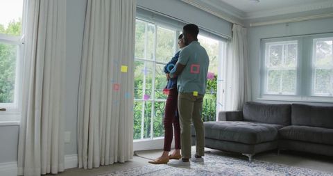 Couple admiring scenic view in elegant living room