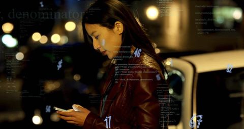 Asian woman reading phone on night street wearing brown leather jacket with code overlay