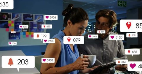 Business Colleagues Analyzing Data on Tablet with Notifications Overlay