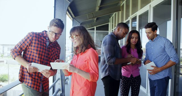 Diverse group of professionals working together on outdoor office balcony - Download Free Stock Images Pikwizard.com