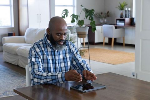 Senior Man Engaging with Tablet in Cozy Living Room