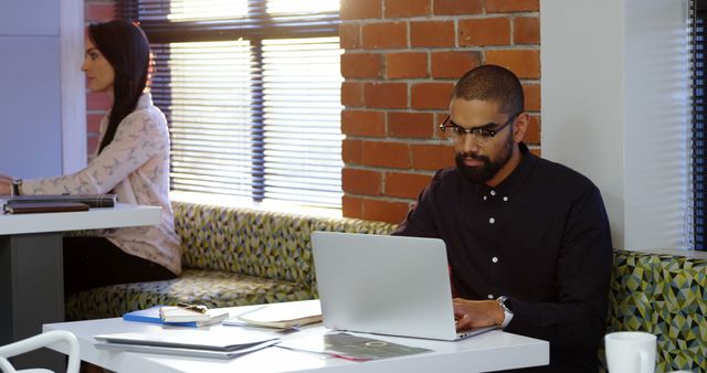 Diverse business team working on laptops in modern office - Download Free Stock Images Pikwizard.com