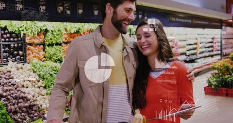 Young couple using tablet while grocery shopping in produce aisle with digital analytics