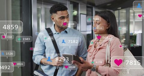 Professionals collaborating with tablet and social media analytics overlays in modern office lobby