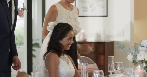 Bride smiling with guests at elegant indoor wedding reception