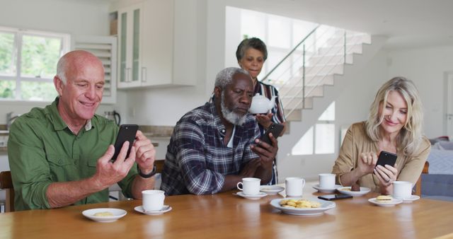 Group of Seniors Enjoying Coffee and Smartphones in Modern Home - Download Free Stock Images Pikwizard.com