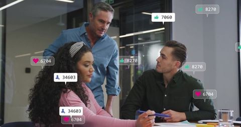 Diverse team discussing work with social media interface icons