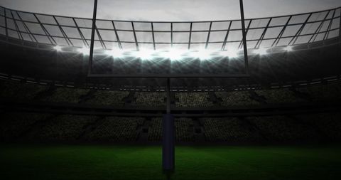 Football Stadium at Night with Floodlit Goalposts on Cloudy Sky - Download Free Stock Images Pikwizard.com