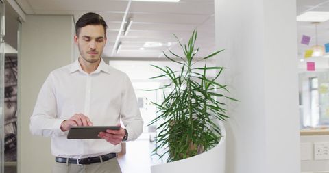 Businessman Using Tablet in Modern Office Environment