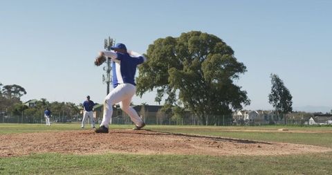 Baseball Pitcher Throwing on Sunny Day at Community Field