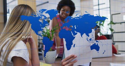 Global teamwork collaborating over reports with world map data overlay in modern office