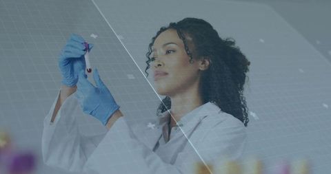 Female scientist examining blood vial with digital hud overlay, data grid in clinical lab