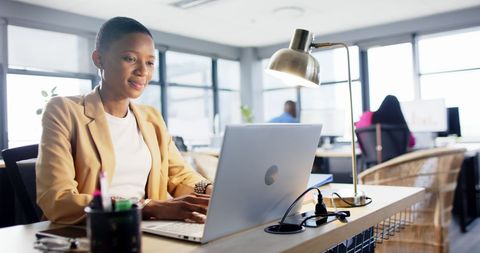 Confident African American Businesswoman Working on Laptop in Modern Office - Download Free Stock Images Pikwizard.com