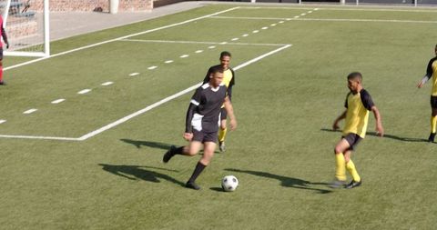High School Soccer Players Passing Ball During Intense Practice