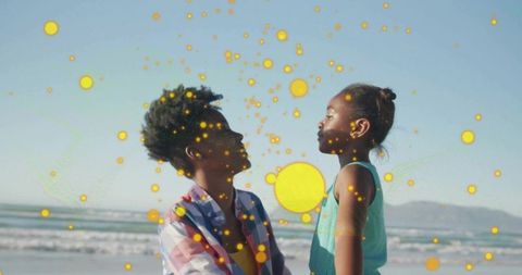 Mother Holding Daughter Amidst Artistic Dots on Sunny Beach