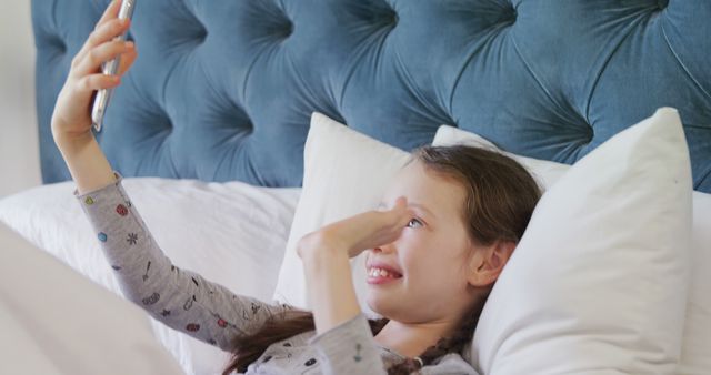 Young Girl Lying in Bed Taking Selfie with Smartphone - Download Free Stock Images Pikwizard.com