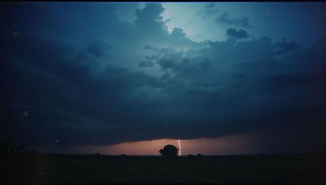 Dramatic Lightning Over Lone Tree at Dusk