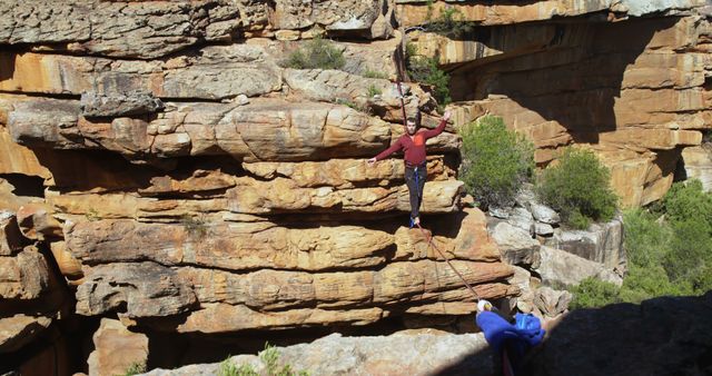 Man balancing on a slackline across rocky canyon - Download Free Stock Images Pikwizard.com