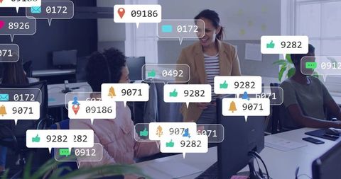 Smiling leader leaning toward coworker in modern office with social notification overlays