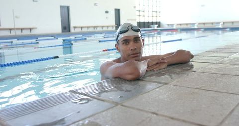 Young Athlete Swimmer Resting at Indoor Poolside - Download Free Stock Images Pikwizard.com
