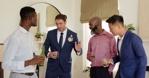 Groom Sharing Toast with Friends in Formal Celebration