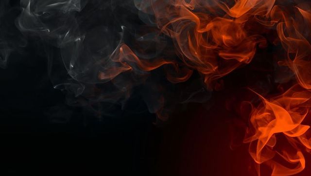 Abstract Smoke Swirls in Fiery Orange and Gray on Dark Background