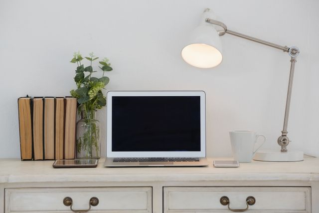 Ideal for articles or blogs about home office setups, productivity tips, minimalist design, or remote work. Perfect for illustrating concepts of modern workspaces, clean and organized environments, and technology integration in daily life.
