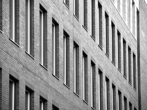 Row of Brick-Building Windows in Black and White Perspective
