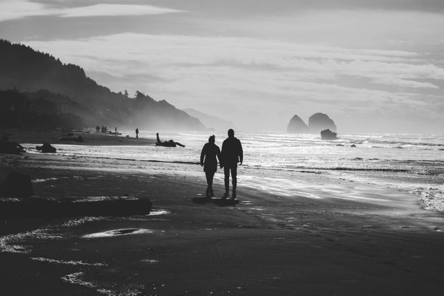 Silhouetted couple walking along beach with scenic coastline and calm ocean at sunset. Perfect for themes related to romance, vacations, nature, tranquility, peaceful moments, and togetherness. Suitable for travel promotions, greeting cards, and lifestyle blogs.
