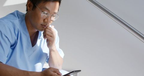 Medical Professional Using Smartphone on Hospital Break