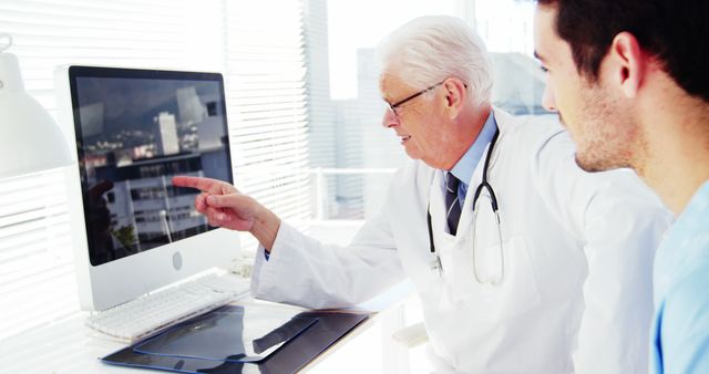 Male doctor and coworker discussing over computer at the hospital 4k - Download Free Stock Photos Pikwizard.com
