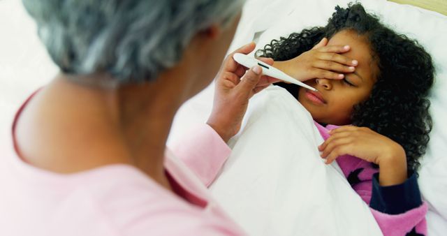 Caregiver Checking Temperature of Sick Child Lying in Bed - Download Free Stock Images Pikwizard.com