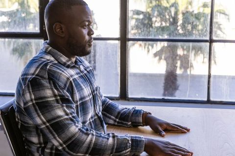 Focused Professional Gazing Through Modern Office Window