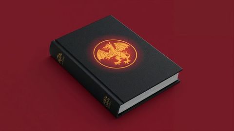Fantasy black hardcover book with glowing dragon emblem
