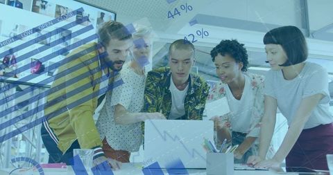 Diverse Team Analyzing Financial Data in Creative Office