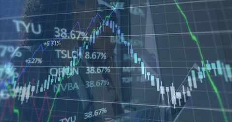 Financial Trading Team Analyzing Candlestick Charts on Laptop with Office Reflection