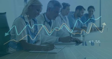 Medical team analyzing data with overlaid graphs at meeting