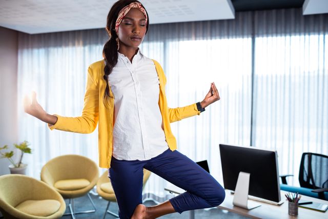 Businesswoman doing yoga at the office