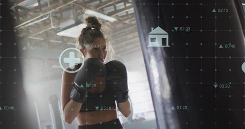 Female Boxer Training in Industrial Gym Wearing Gloves with Digital HUD Overlay