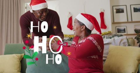 Couple celebrating christmas with gift exchange and joyful atmosphere