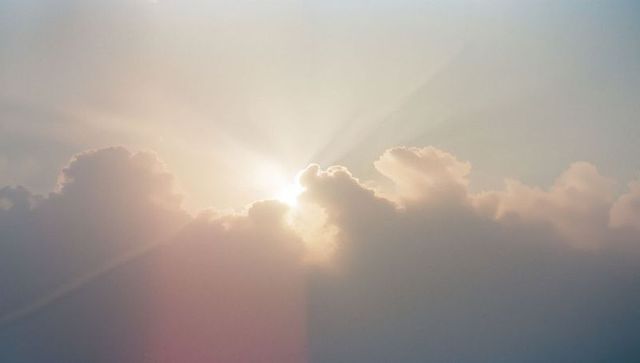 Sun Rays Streaming Through Cloud Highlights Dawn Serenity