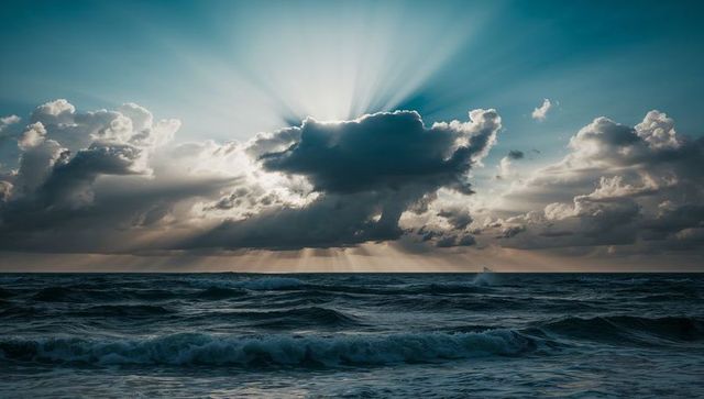 Dramatic ocean waves under radiant sunlit clouds