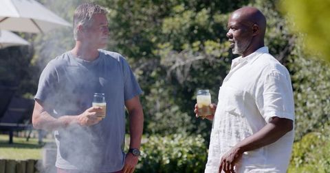 Diverse Male Friends Enjoying Drinks Barbecue Outdoor Gathering