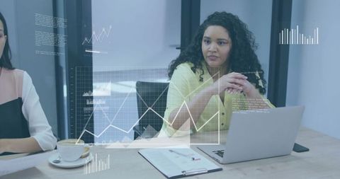 Professional businesswoman analyses data charts in modern workspace